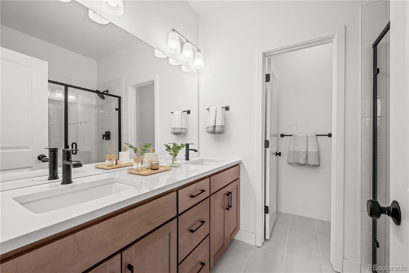 2736 West 68th Avenue Denver, CO 80221 - Photo 26 of 44 a bathroom with a granite countertop sink mirror and double