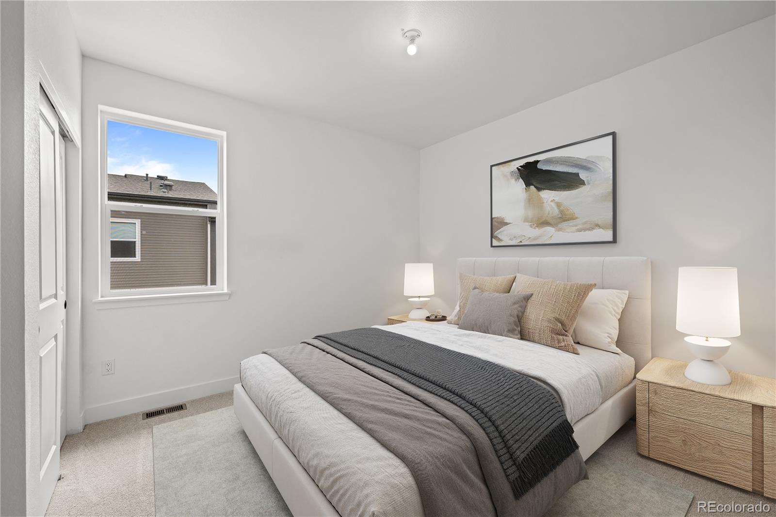 2736 West 68th Avenue Denver, CO 80221 - Photo 29 of 44 a bedroom with a bed and a painting on the wall
