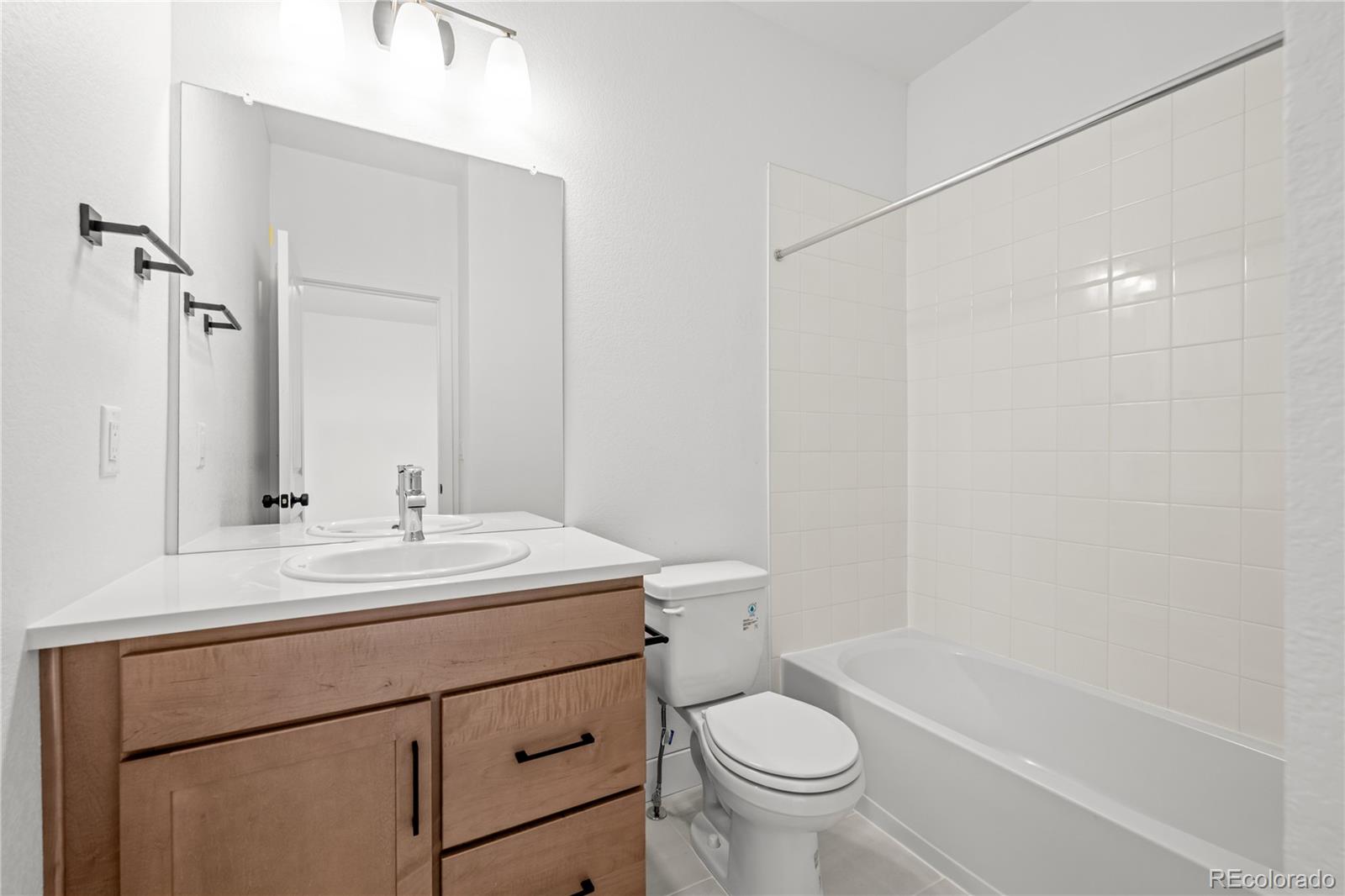 2736 West 68th Avenue Denver, CO 80221 - Photo 32 of 44 a bathroom with a sink a toilet and shower