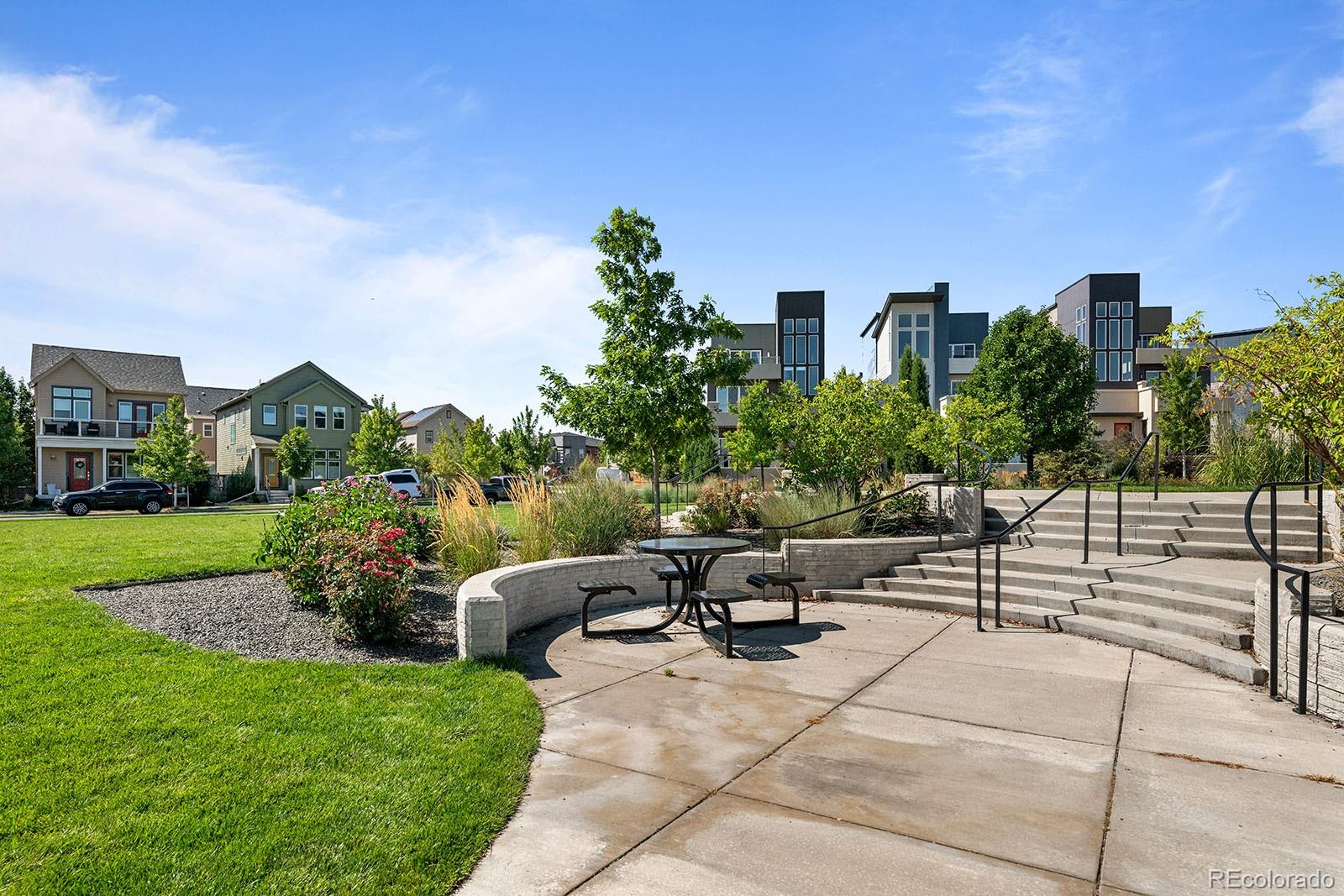 2736 West 68th Avenue Denver, CO 80221 - Photo 41 of 44 a view of a patio with couches and a table and chairs with plants and trees