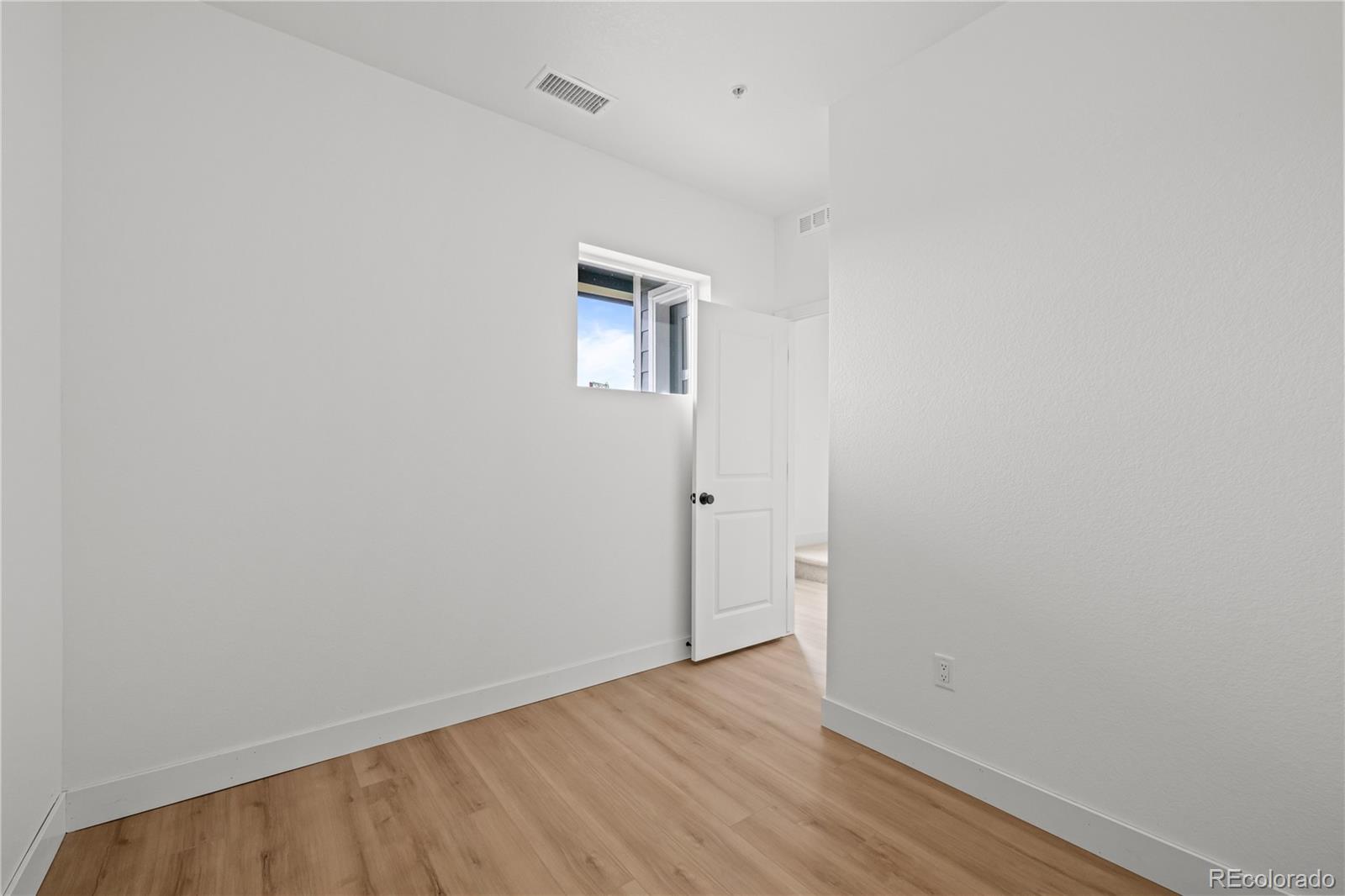 2736 West 68th Avenue Denver, CO 80221 - Photo 6 of 44 a view of an empty room with wooden floor