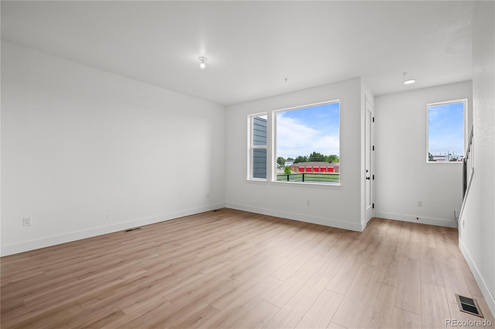 2736 West 68th Avenue Denver, CO 80221 - Photo 7 of 44 a view of an empty room with wooden floor and a window