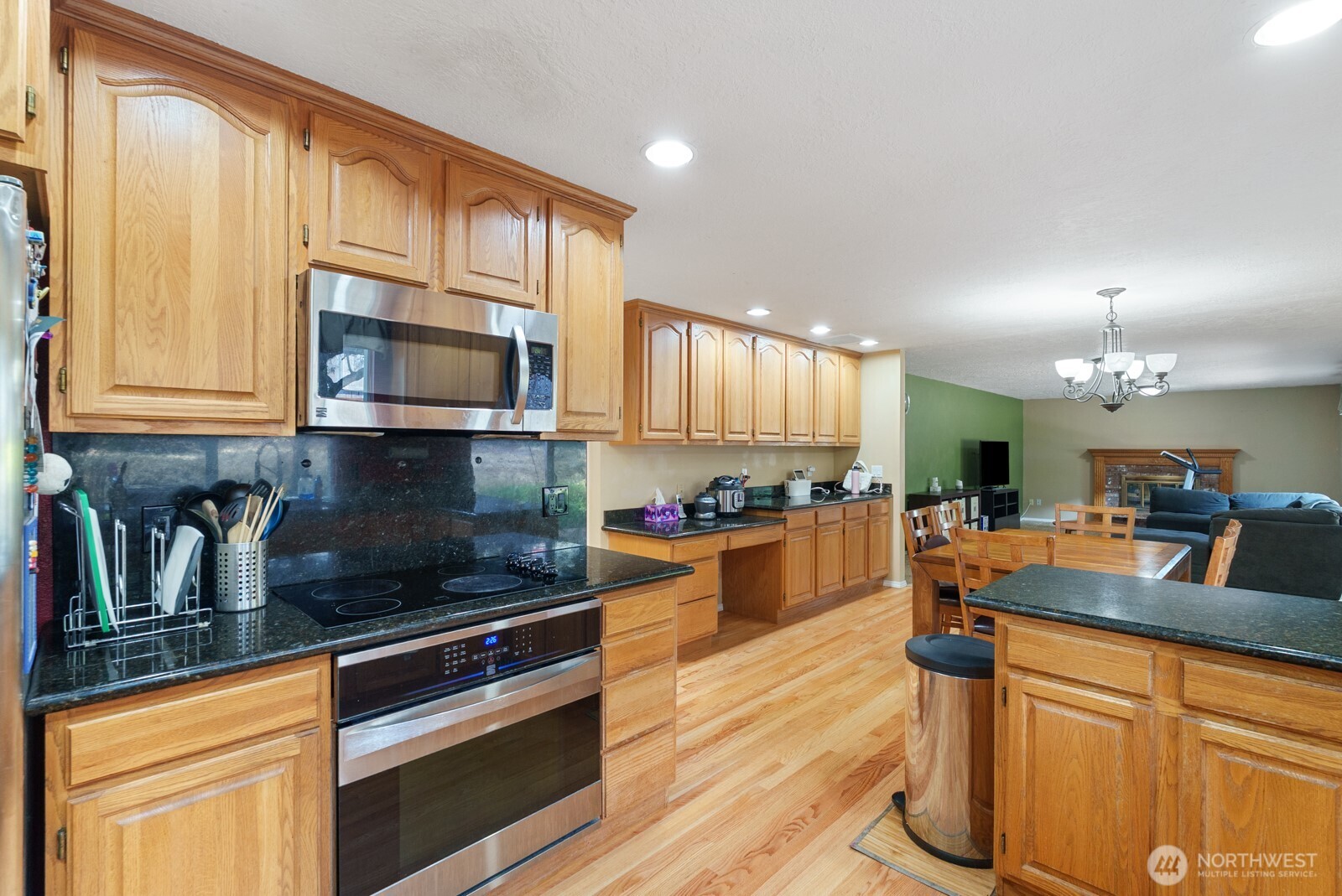 32738 6th Avenue Southwest Federal Way, WA 98023 - Photo 10 of 40 a kitchen with stainless steel appliances wooden floor sink and cabinets