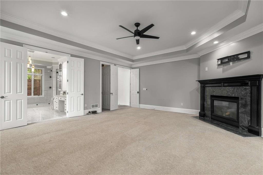1483 Jones Road Roswell, GA 30075 - Photo 16 of 37 a view of a livingroom with a ceiling fan a fireplace