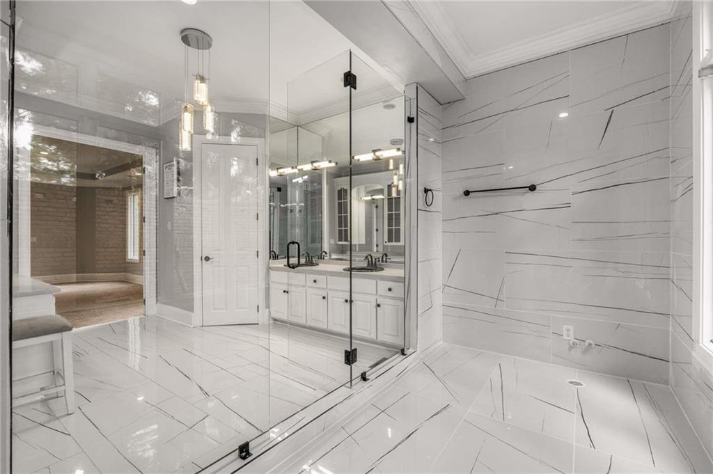 1483 Jones Road Roswell, GA 30075 - Photo 18 of 37 a bathroom with a glass shower door and a sink