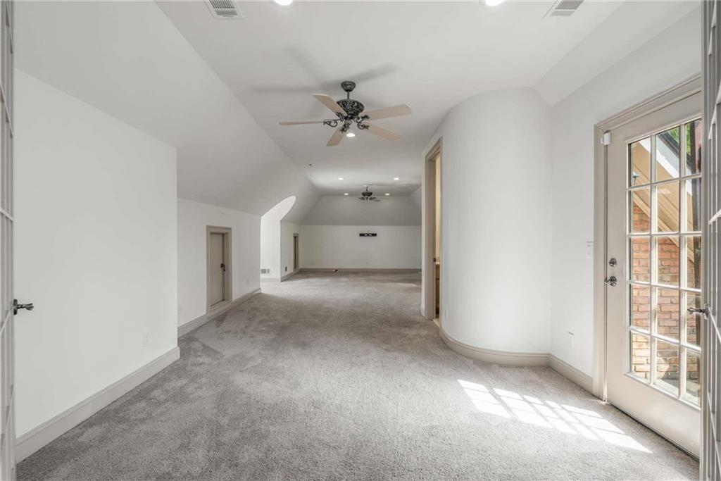 1483 Jones Road Roswell, GA 30075 - Photo 20 of 37 a view of a big room with windows and chandelier fan