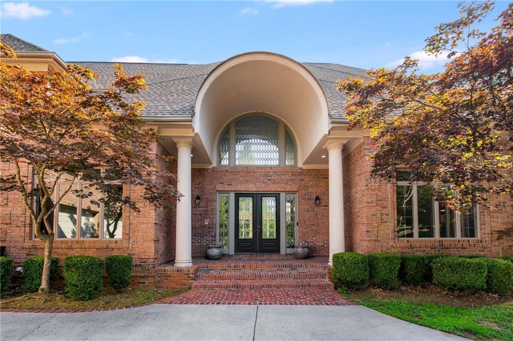 1483 Jones Road Roswell, GA 30075 - Photo 2 of 37 a front view of a house with garden
