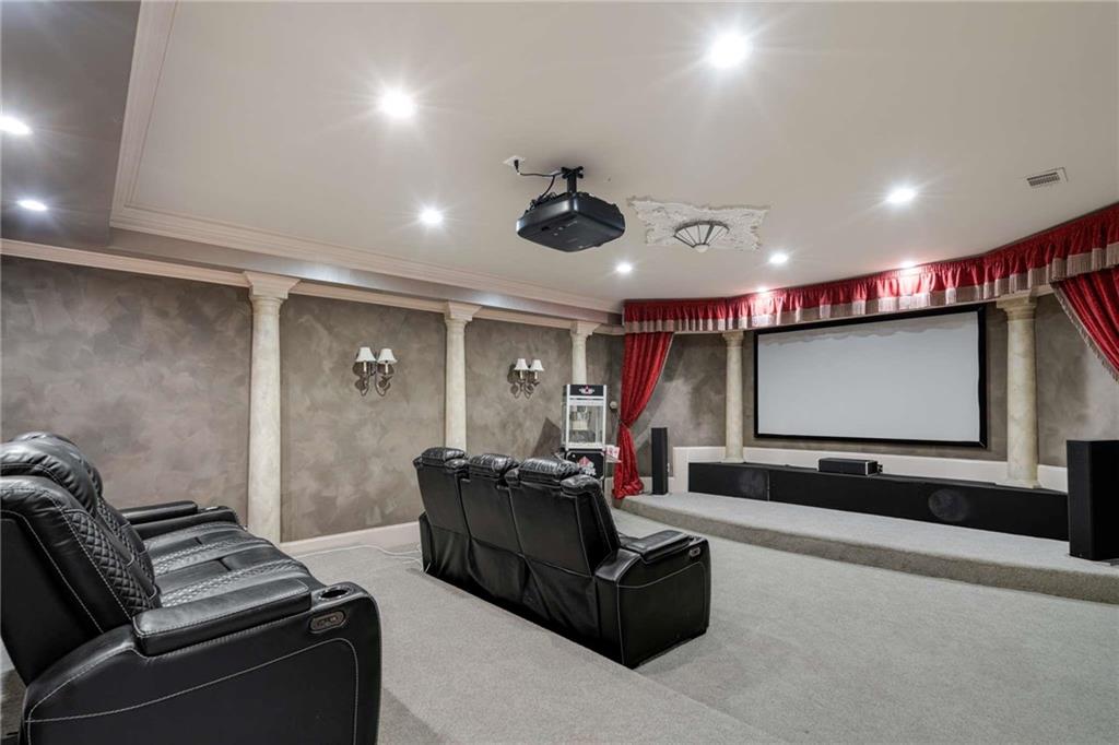 1483 Jones Road Roswell, GA 30075 - Photo 3 of 37 a living room with furniture and a projector screen