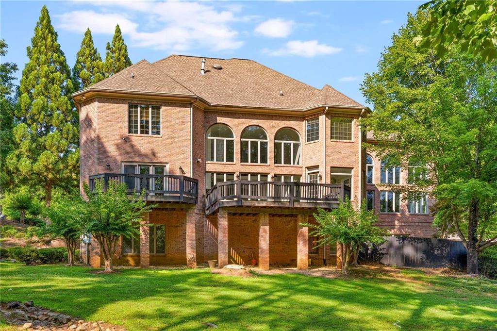 1483 Jones Road Roswell, GA 30075 - Photo 6 of 37 a front view of a house with a garden