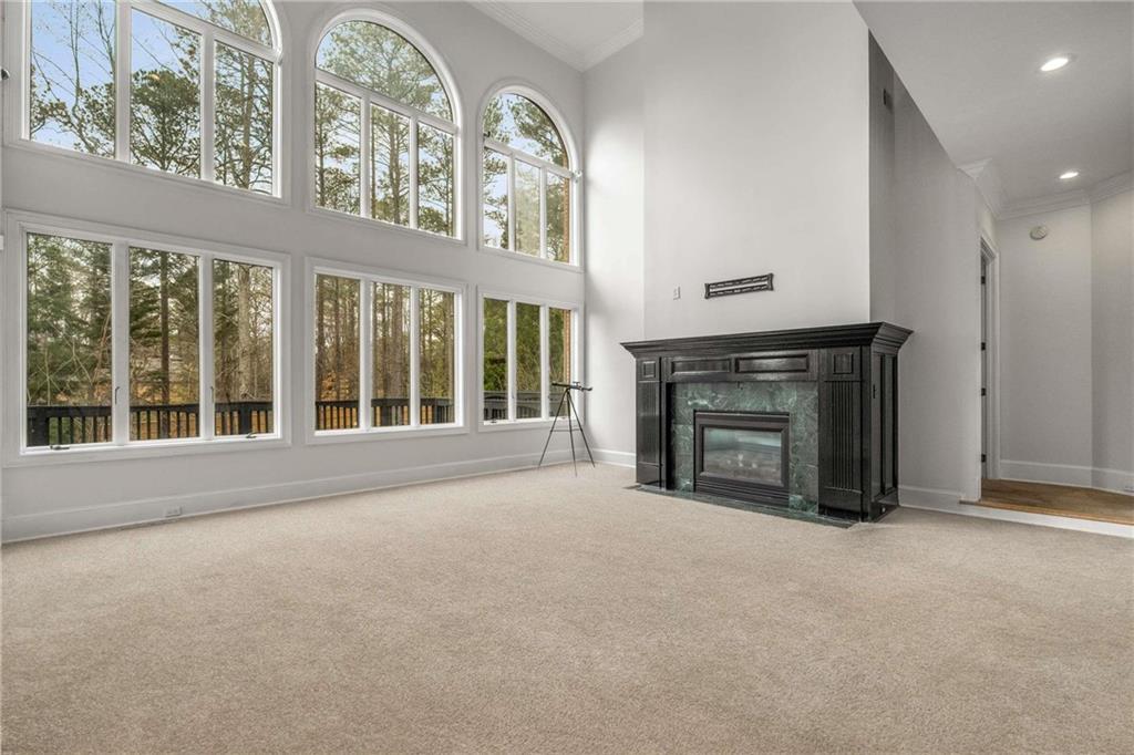 1483 Jones Road Roswell, GA 30075 - Photo 9 of 37 a view of an empty room with a fireplace and a window