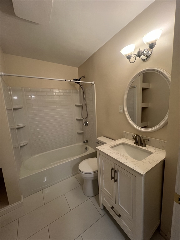 13 Perkins Avenue, Unit 1 Brockton, MA 02301 - Photo 2 of 5 a bathroom with a sink a toilet and shower