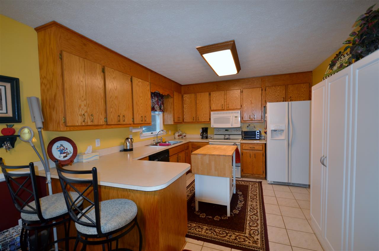 87 Ox Road Waynesboro, VA 22980 - Photo 3 of 25 a kitchen with stainless steel appliances a table chairs and a refrigerator