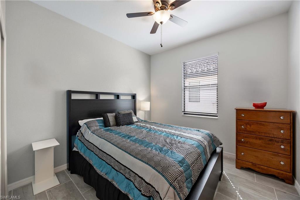 1602 Santiago Circle Naples, FL 34113 - Photo 23 of 49 Bedroom with baseboards and a ceiling fan