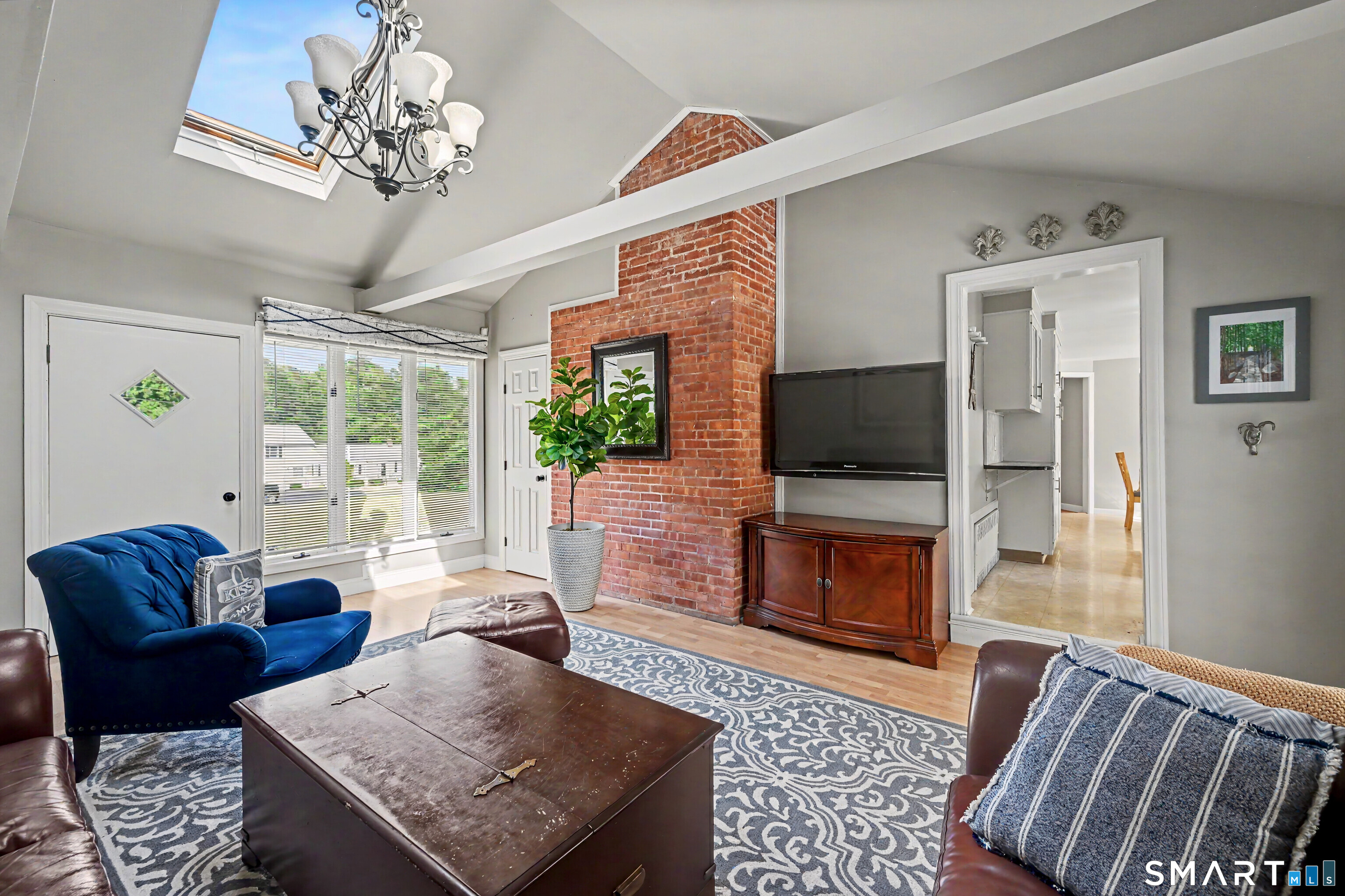 524 Ferry Road Orange, CT 06477 - Photo 15 of 40 a living room with furniture a flat screen tv and a fireplace