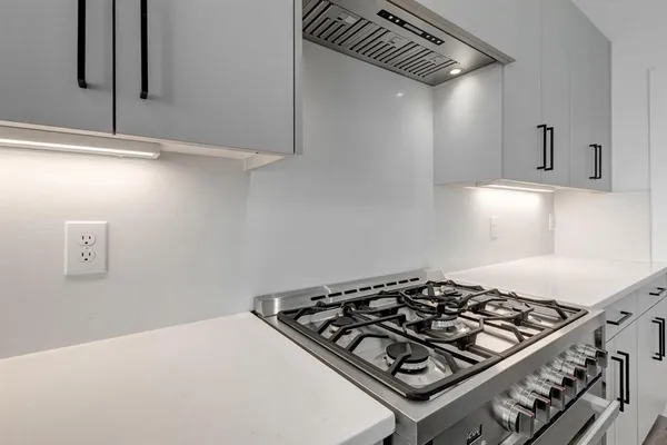a stove top oven sitting inside of a kitchen