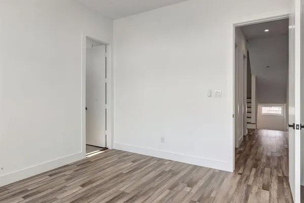 a view of a hallway with wooden floor
