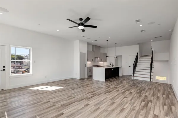 a view of kitchen with wooden floor and electronic appliances