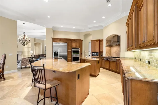 a large kitchen with a table and chairs in it