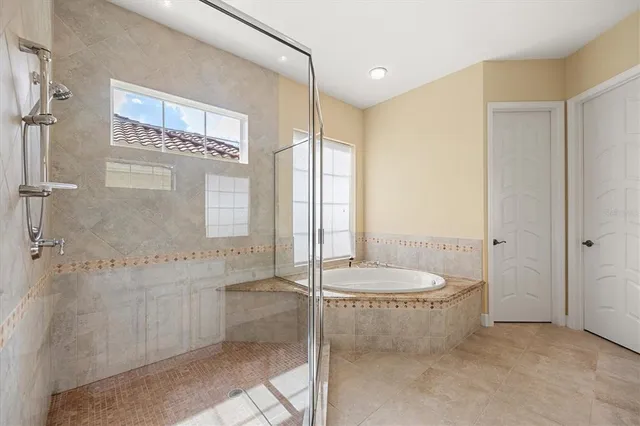 a bathroom with a granite countertop sink a toilet and shower