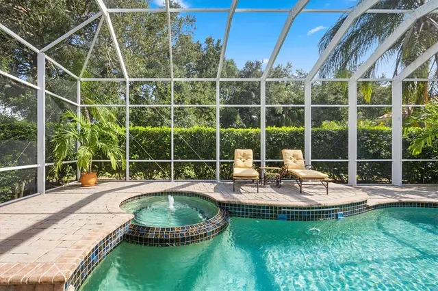 a view of a house with backyard sitting area and swimming pool