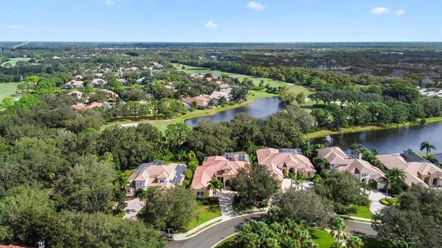 an aerial view of lake residential houses with outdoor space and lake view