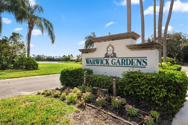 a kitchen with stainless steel appliances kitchen island granite countertop a table and chairs in it