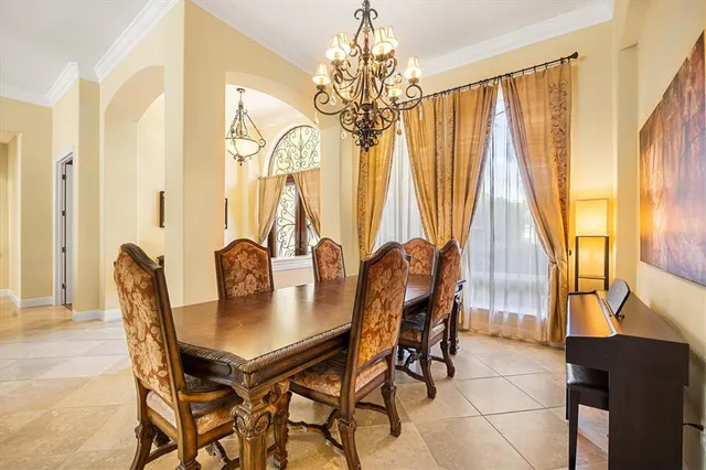 a view of a dining room with furniture and chandelier