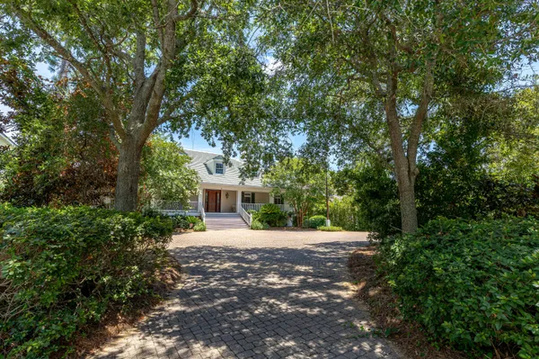 a living room with furniture a fireplace and a chandelier