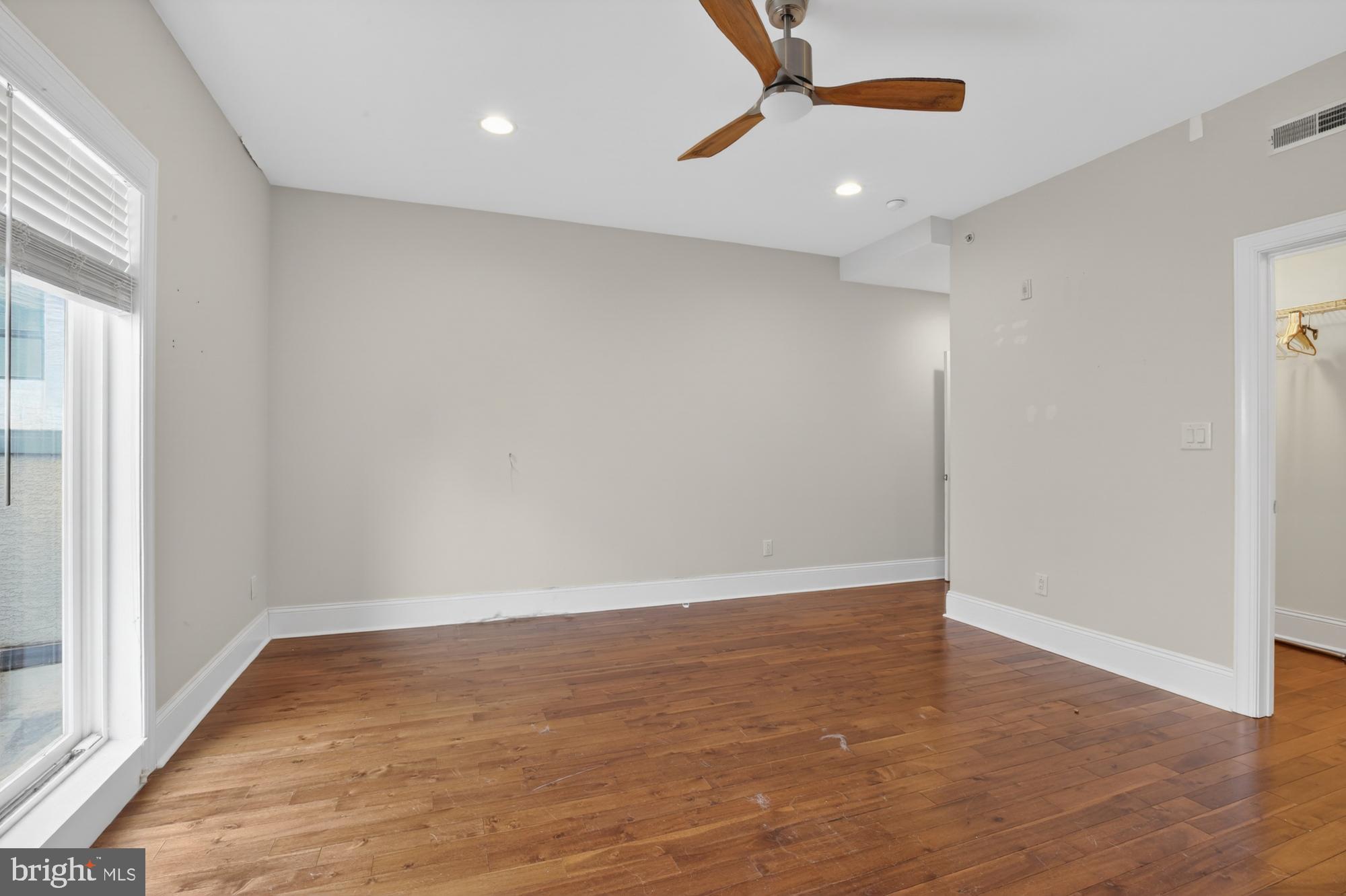 946 North 2nd Street, Unit 5 Philadelphia, PA 19123 - Photo 22 of 31 an empty room with wooden floor and windows