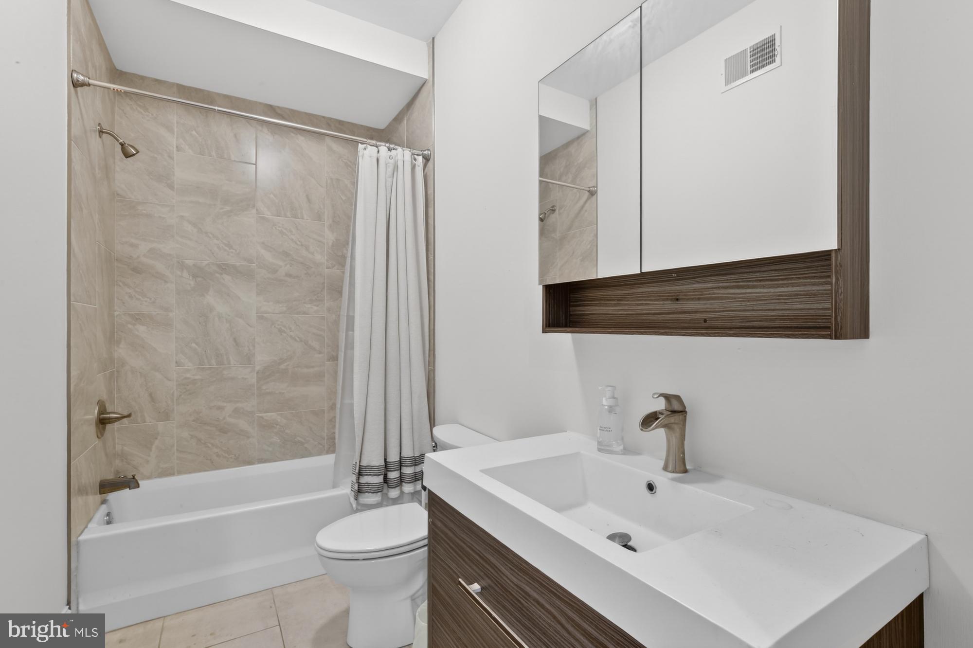946 North 2nd Street, Unit 5 Philadelphia, PA 19123 - Photo 7 of 31 a bathroom with a sink a toilet and shower