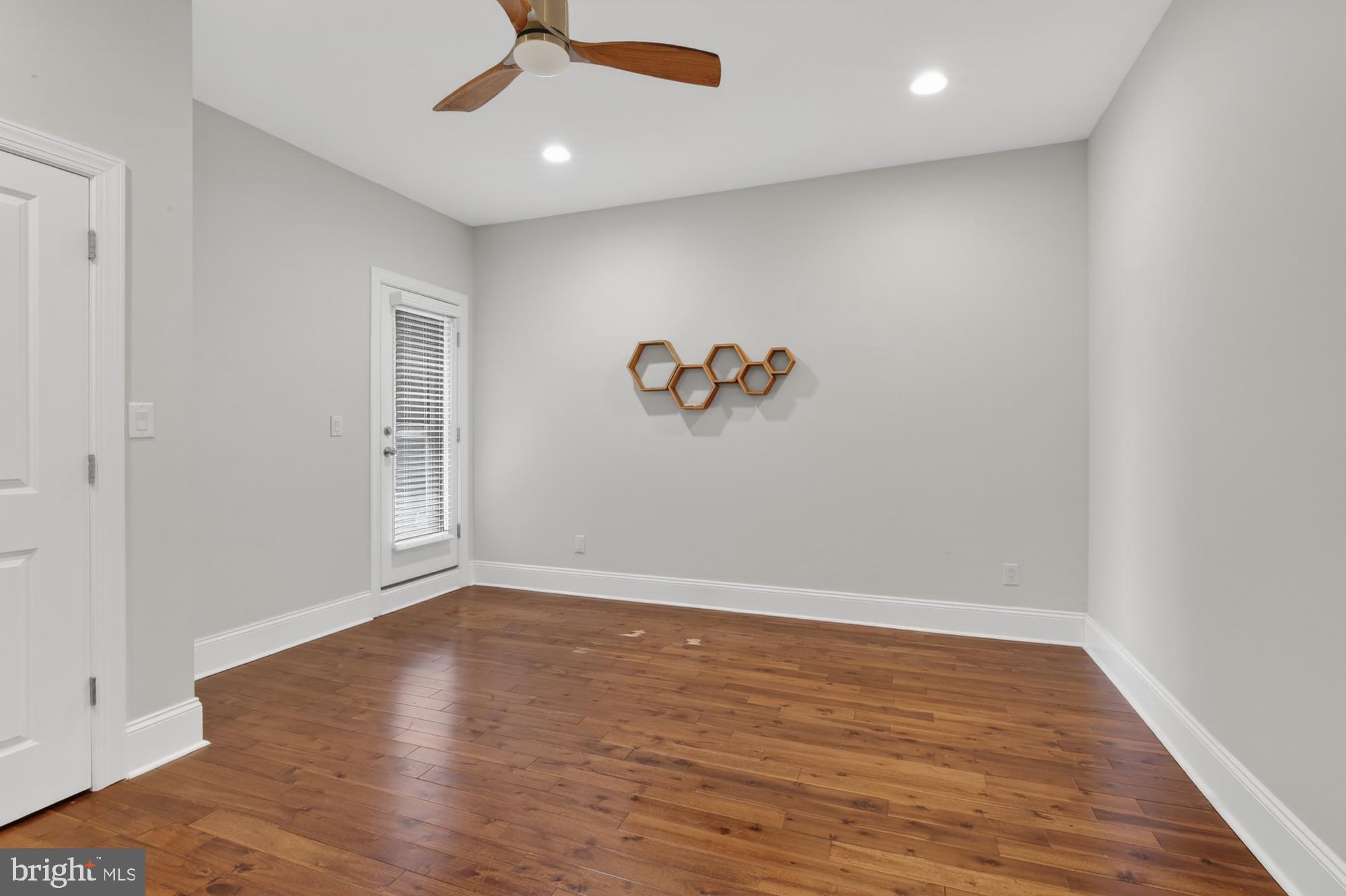 946 North 2nd Street, Unit 5 Philadelphia, PA 19123 - Photo 8 of 31 an empty room with wooden floor and windows