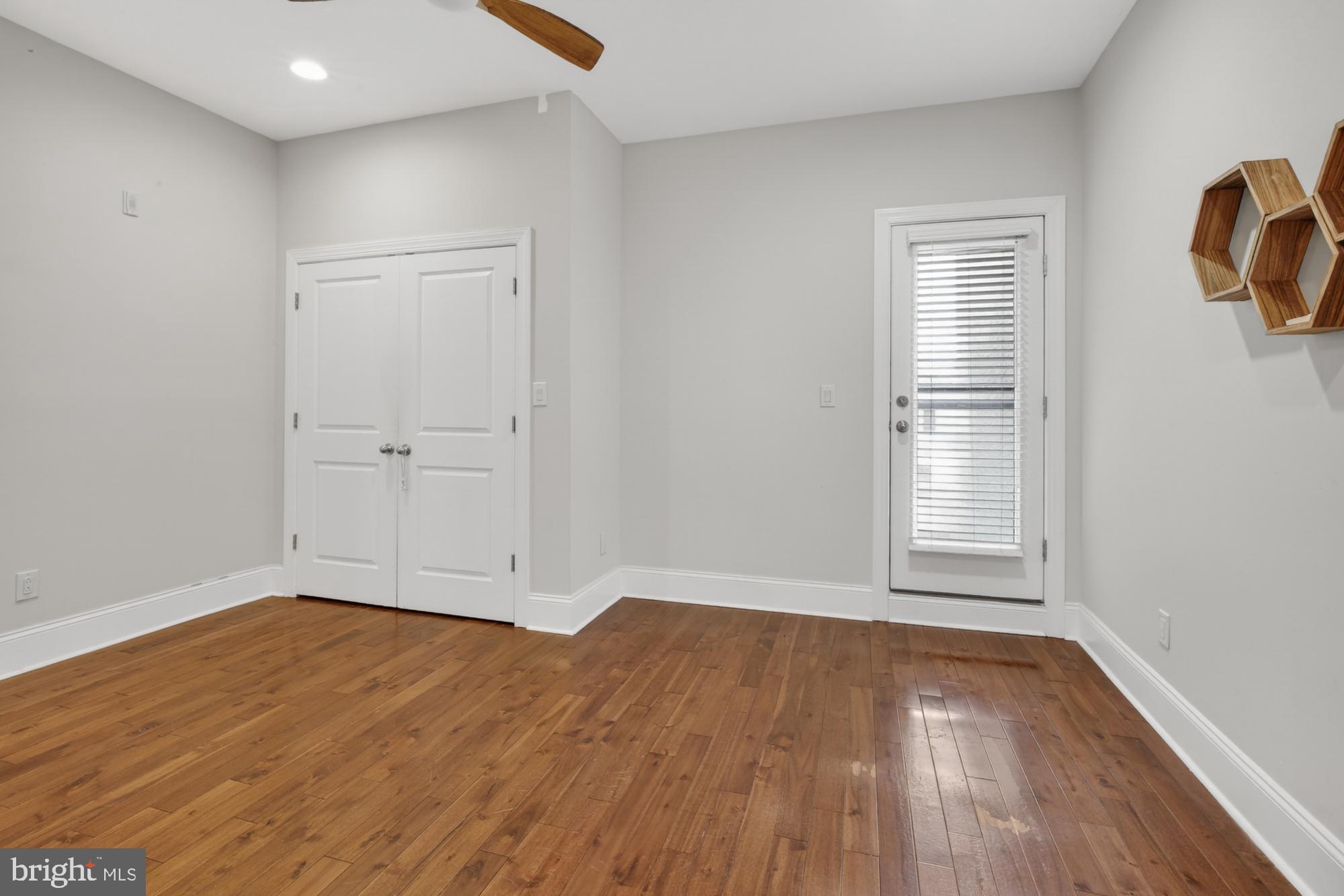 946 North 2nd Street, Unit 5 Philadelphia, PA 19123 - Photo 10 of 31 an empty room with wooden floor and windows