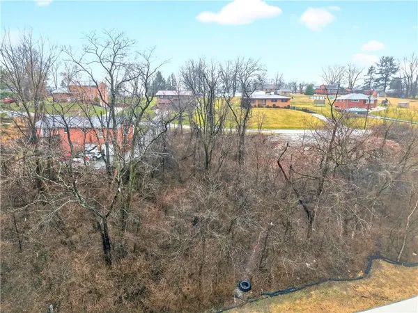 a view of a swimming pool with an outdoor seating and a yard