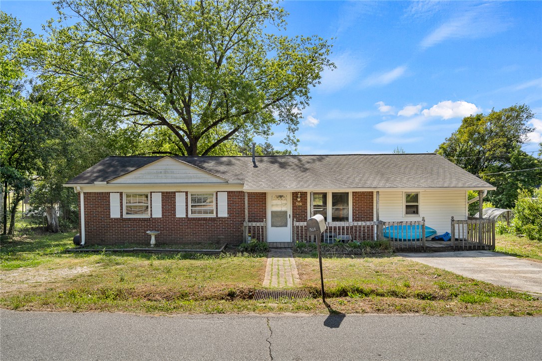 308 Clayton Street Central, SC 29630 - Photo 1 of 31 This cozy home presents a welcoming facade with a covered entry and a paved driveway.