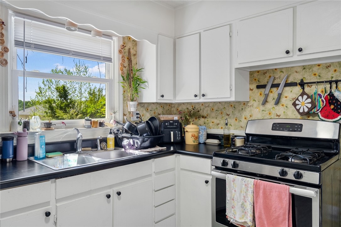 308 Clayton Street Central, SC 29630 - Photo 11 of 31 This cozy kitchen features a window overlooking lush greenery, perfect for sun-drenched meal preparation.