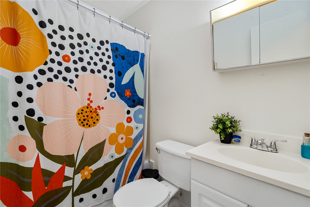 308 Clayton Street Central, SC 29630 - Photo 16 of 31 This bathroom features a sleek vanity and a shower with a vibrant, eye-catching curtain.