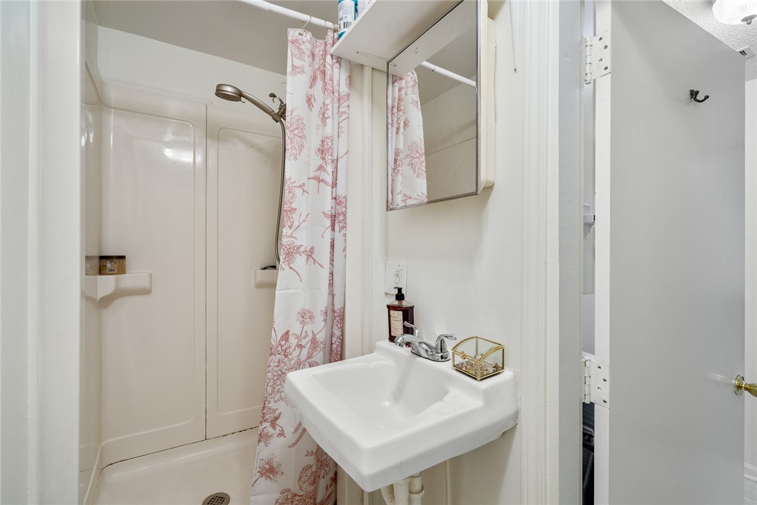 308 Clayton Street Central, SC 29630 - Photo 20 of 31 This bathroom features a shower and a classic wall-mounted sink, offering a clean and functional space.