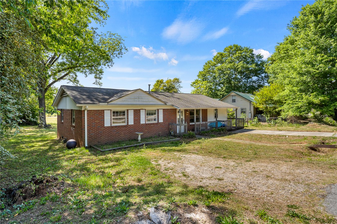 308 Clayton Street Central, SC 29630 - Photo 2 of 31 This charming residence offers a peaceful retreat with mature trees and a welcoming facade.