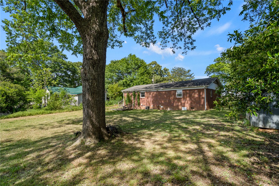 308 Clayton Street Central, SC 29630 - Photo 23 of 31 This spacious yard features mature trees and a charming brick exterior, perfect for outdoor living.