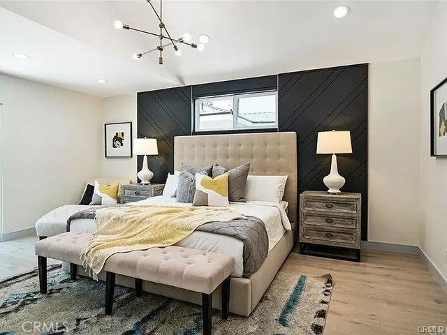 a bedroom with furniture and a ceiling fan
