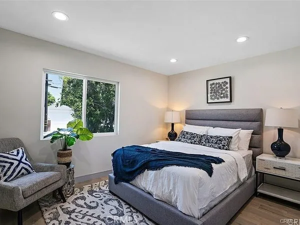 a bedroom with a bed and a window