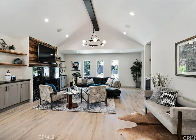 a living room with furniture or couch and a flat screen tv