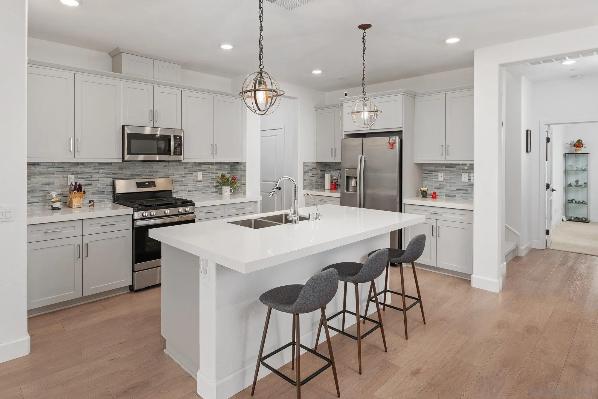 1091 Barry Place Escondido, CA 92026 - Photo 1 of 40 a kitchen that has a lot of cabinets a sink and appliances in it