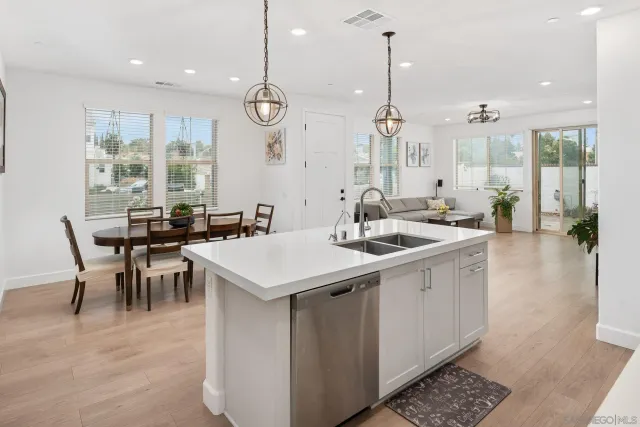 a large kitchen with a table and chairs