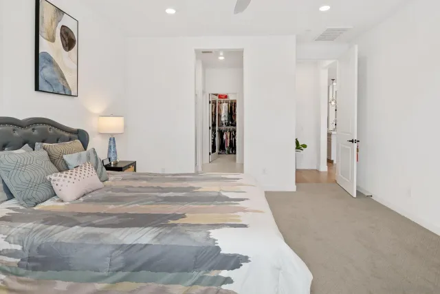 a bedroom with a bed and a lamp