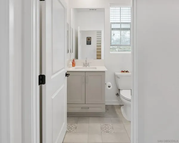 a bathroom with a sink a toilet and a window