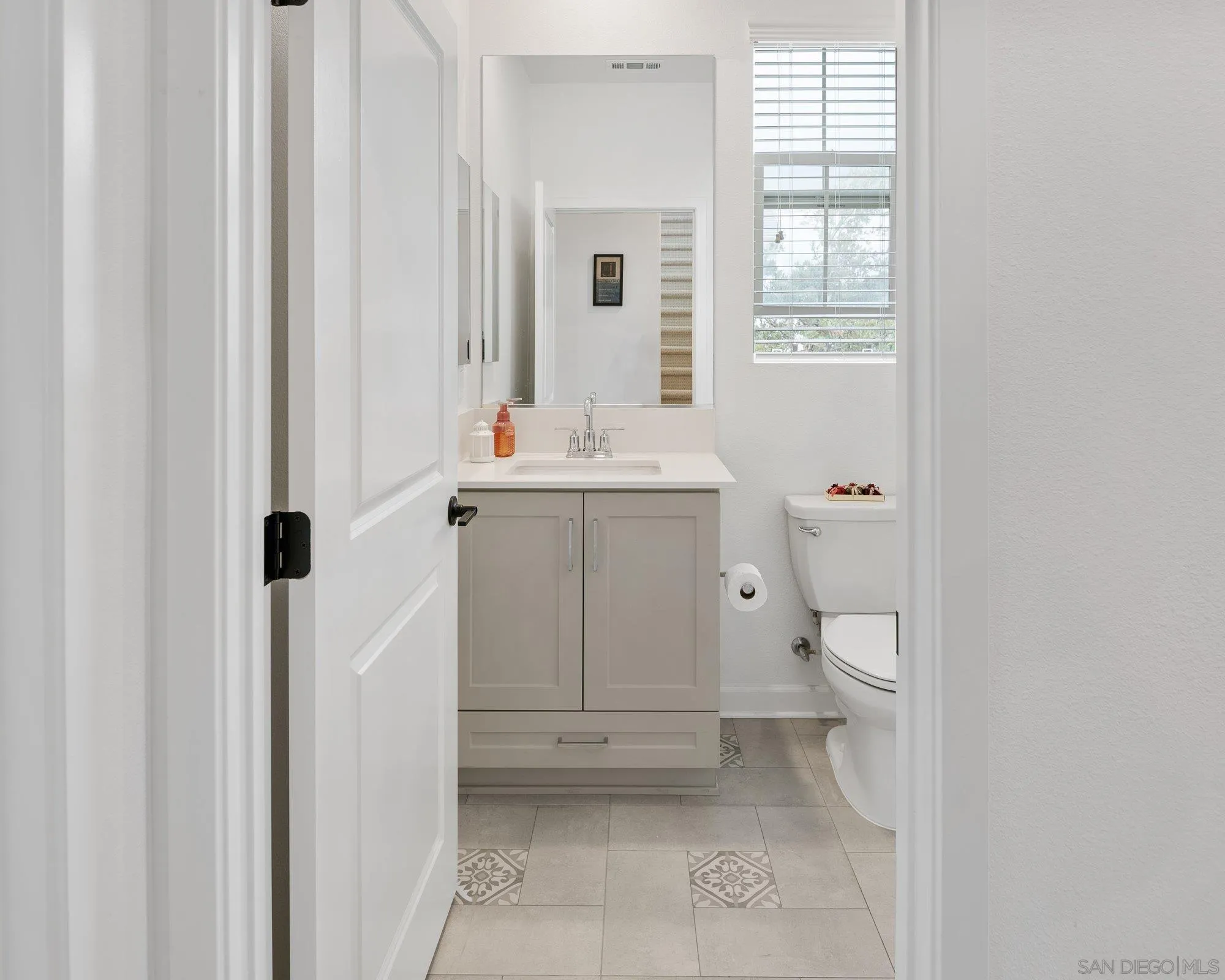1091 Barry Place Escondido, CA 92026 - Photo 18 of 40 a bathroom with a sink a toilet and a window