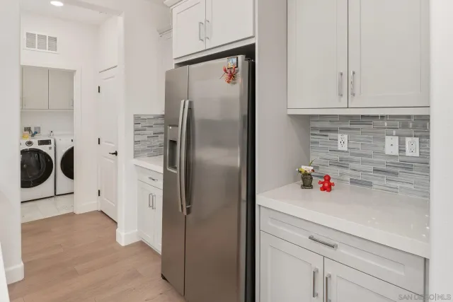 a kitchen with stainless steel appliances cabinets and a refrigerator
