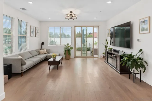 a living room with furniture large windows and a flat screen tv