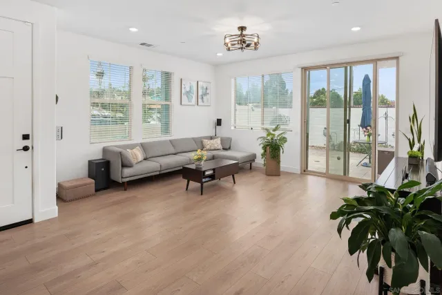 a living room with furniture and large windows